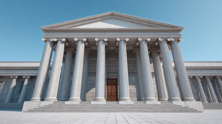 A striking neoclassical building featuring tall columns and a large wooden door. The clear blue sky enhances its majestic appearance, making it perfect for legal themes.の素材