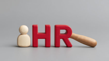 This image showcases a wooden figure next to bold red letters representing HR, symbolizing human resource management, teamwork, and employee engagement in the modern workplace.の素材