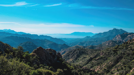 A breathtaking view of a mountain range with clear blue skiesの素材