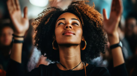 A woman with raised hands expresses joy and spirituality amidst a lively crowd, capturing an inspiring moment of celebration and connection.の素材