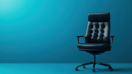 A minimalist shot of a black leather office chair centered on a gradient blue background with ample copy space.の素材