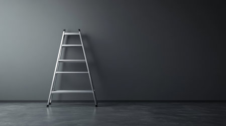 A propped aluminum ladder in a minimalist gray-walled room, with a focus on functionality and space.の素材
