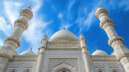A stunning view of a white mosque with intricate details and towering minarets set against a clear blue sky, showcasing religious architecture and cultural heritage.の素材