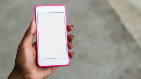 A close-up image showcasing a hand holding a smartphone with a blank screen, ideal for themes of technology, communication, and lifestyle in modern contexts.の素材