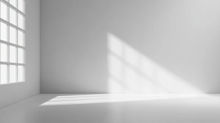 A spacious and bright interior showcasing minimalism, where soft natural light creates gentle shadows on the pristine white walls and smooth floor, ideal for inspiration and creativity.の素材