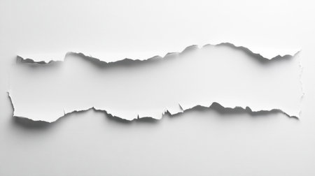 A close-up of torn white paper creating a jagged edge effect against a smooth backdrop, perfect for minimalistic designs and creative graphic applications.の素材