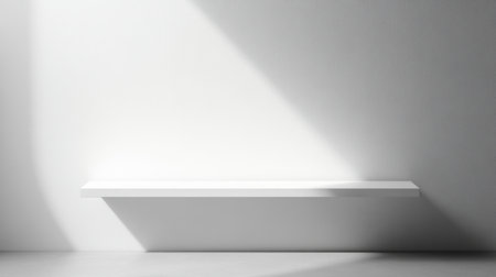 A minimalist white shelf is positioned against a smooth wall, casting soft shadows in a contemporary space, ideal for showcasing decor or emphasizing simplicity in design.の素材
