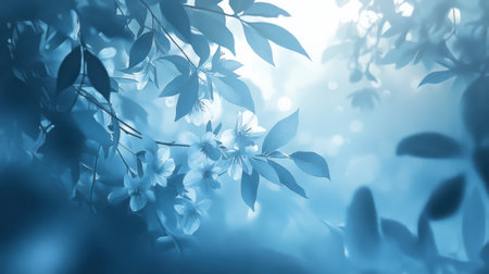 A tranquil blue floral background featuring soft blossoms and leaves, creating a serene and dreamy atmosphere perfect for nature-themed projects and designs.の素材