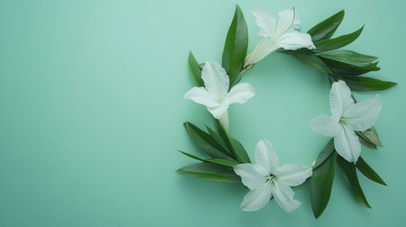 A serene floral arrangement featuring elegant white lilies surrounded by fresh green leaves on a soft mint green background, perfect for seasonal decor or celebrations.の素材