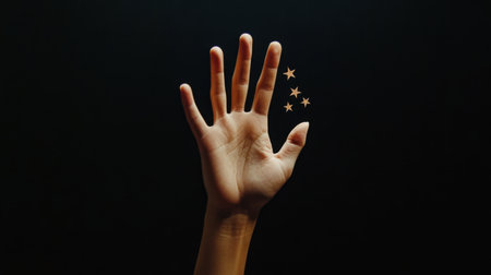 A solitary hand reaching upward against a dark background, adorned with small stars, symbolizes hope and aspiration. This artistic image evokes emotion and creativity.の素材