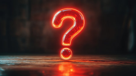 A vibrant red glowing question mark lies on a dark surface, symbolizing inquiry and curiosity. Ideal for concepts related to questioning and exploration.の素材