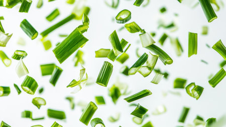 A vibrant display of freshly chopped green vegetables falling through the air, creating a dynamic and lively scene. Ideal for cooking and healthy eating themes.の素材