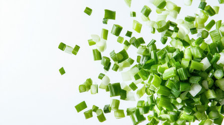 Vibrant chopped green onions scattered on a light background, perfect for adding color and flavor to various dishes. Ideal for recipes and presentations.の素材