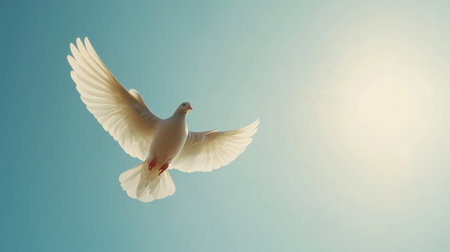 A serene white bird soaring high in a clear blue sky, capturing the essence of freedom and beauty. The sunlight highlights its wings, creating an uplifting scene.の素材