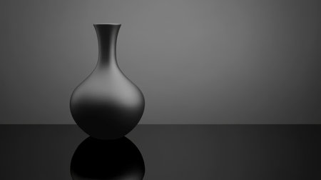 A sleek black vase stands elegantly on a smooth surface, creating a striking minimalist aesthetic. Its refined shape and texture enhance contemporary decor.の素材