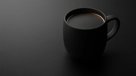 A sleek black coffee mug positioned on a dark surface, capturing a minimalist aesthetic. The simplicity highlights the warm beverage inside, ideal for modern decor.の素材
