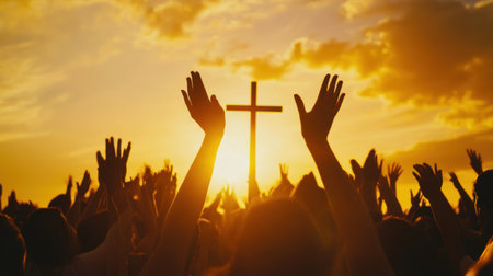 A vibrant sunset scene showing worshippers raising their hands in front of a cross. This image captures the essence of community and spiritual devotion during a religious gathering.の素材