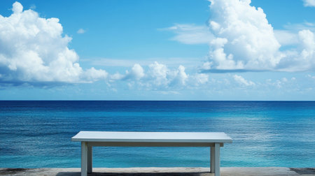 A serene white bench sits alone by the tranquil ocean, under a vast blue sky adorned with soft clouds. Captures the essence of peace and relaxation.の素材