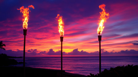 A stunning tropical sunset featuring tiki torches with vibrant flames against a colorful sky. A serene beach scene ideal for evoking relaxation and vacation vibes.の素材