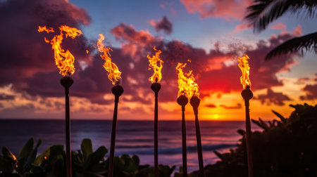 Vibrant tiki torches flicker against a breathtaking tropical sunset, illuminating the serene ocean waves. Perfect for capturing paradise and relaxation.の素材