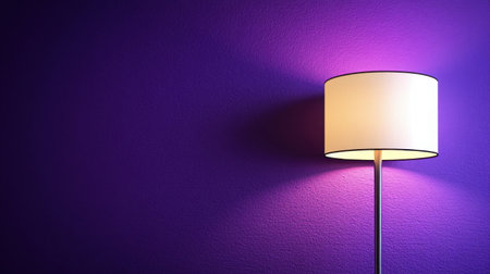 A stylish floor lamp casts a warm glow against a vibrant purple wall, creating an inviting atmosphere. Ideal for modern interior designs and cozy spaces.の素材