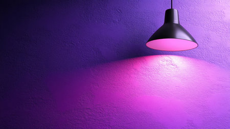 A modern hanging lamp emits a vibrant purple glow, casting soft shadows on a textured wall. The design adds a stylish touch to any modern interior space.の素材