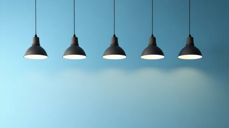 A collection of modern industrial hanging lamps against a soft blue backdrop, ideal for showcasing contemporary interior design aesthetics and lighting options.の素材