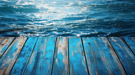 A stunning view of sunlight shimmering on blue ocean waves, captured from a weathered wooden pier, ideal for projects related to relaxation, travel, and nature.の素材