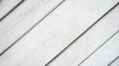 A textured white concrete surface displaying diagonal lines and slight imperfections, perfect for backgrounds in modern design and architectural projects.の素材