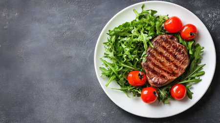 A beautifully presented grilled beef steak on a bed of fresh arugula and vibrant cherry tomatoes, ideal for showcasing healthy and gourmet meal ideas in culinary settings.の素材