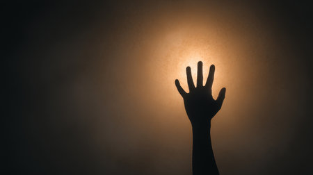 This evocative image showcases a hand stretching out from darkness, symbolizing hope and emergence into light. It captures themes of resilience, aspiration, and new beginnings.の素材