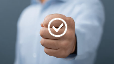 A confident individual presents a certified digital badge featuring a checkmark, symbolizing achievement and compliance within a professional context.の素材