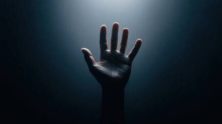 A striking image of a hand reaching out from the depths of darkness, representing hope and emergence. The play of light creates a powerful atmosphere of emotion and depth.の素材