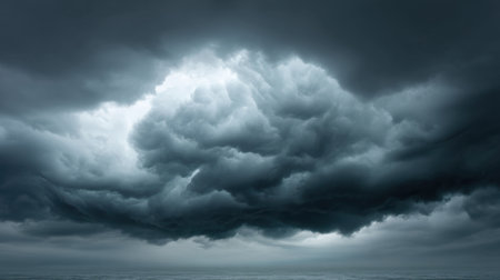 Experience the intensity of a dark, atmospheric sky featuring layered thunderclouds, creating a dramatic backdrop over a calm ocean, perfect for weather themes.の素材