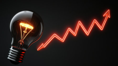 Bright light bulb symbolizes innovative ideas next to a rising trend graph, illustrating growth and progress in business and creativity against a dark background.の素材
