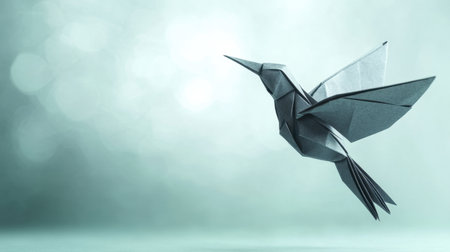Discover a striking origami hummingbird crafted from paper, set against a soothing, blurred background that evokes themes of freedom and creativity in art.の素材