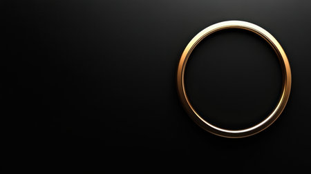 An elegant gold ring is displayed against a dark background, capturing a minimalistic charm ideal for jewelry, wedding themes, or luxury design projects.の素材