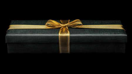 This elegant black gift box adorned with a luxurious gold ribbon creates a stunning presentation, perfect for any special occasion, bringing joy and surprise to your loved ones.の素材