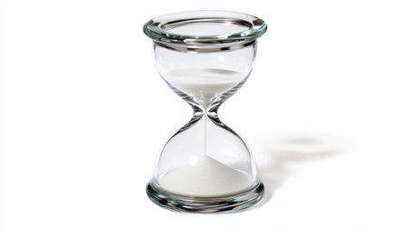 A stunning glass hourglass filled with white sand, representing the flow of time. Ideal for conveying themes of patience, mindfulness, and the beauty of simplicity.の素材