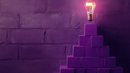 A light bulb radiates atop a purple training pyramid, illustrating growth and creativity in educationの素材