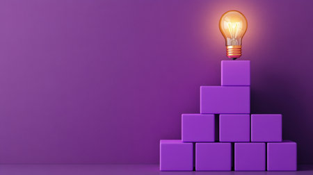 Purple blocks forming a pyramid with a lit bulb above, representing progress and learning growthの素材