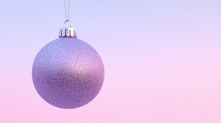A beautiful purple Christmas ornament sparkles against a soft pink background, perfect for winter festivities. Ideal for holiday decor and seasonal design.の素材