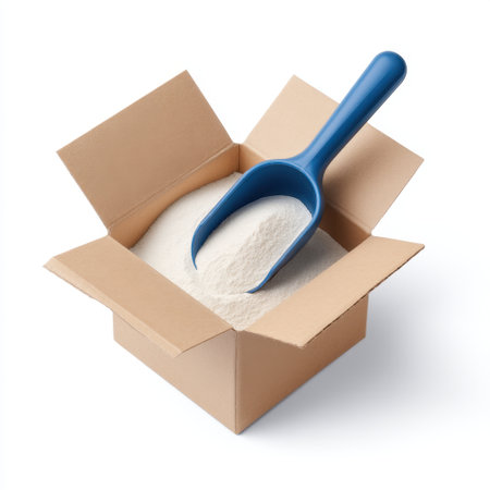 A simple and clean image of a box filled with white powder and a blue scoop, ideal for culinary uses in recipes, cooking, and food preparation. Perfect for a minimalist aesthetic.の素材