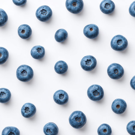 A vibrant arrangement of fresh blueberries on a clean white background. Perfect for health-related themes, food photography, and promoting nutritious eating.の素材