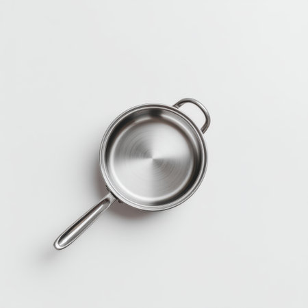 A sleek stainless steel saucepan positioned on a clean white background, ideal for showcasing culinary excellence, cooking techniques, and kitchen aesthetics.の素材
