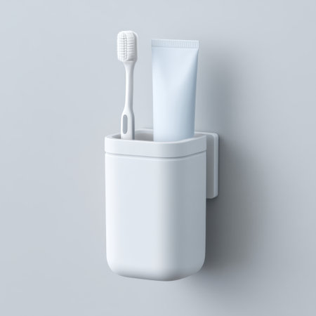 A sleek and tidy toothbrush holder mounted on the wall, featuring a toothbrush and a toothpaste tube, perfect for maintaining a minimalist and organized bathroom space.の素材