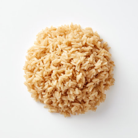 A creative display of freshly cooked brown rice on a white background, ideal for emphasizing nutrition, healthy eating, and culinary inspiration in food photography.の素材
