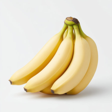 A visually appealing arrangement of fresh yellow bananas on a clean white background, perfect for promoting healthy eating, organic food, and nutrition-related themes.の素材
