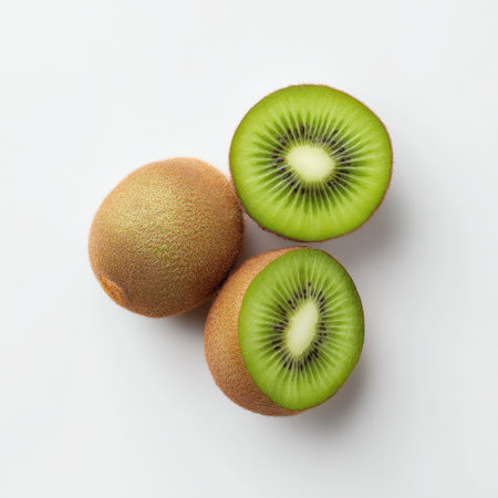 Bright and vibrant kiwi fruit displayed on a clean white background, featuring both whole and halved pieces. Perfect for promoting healthy eating and organic food themes.の素材