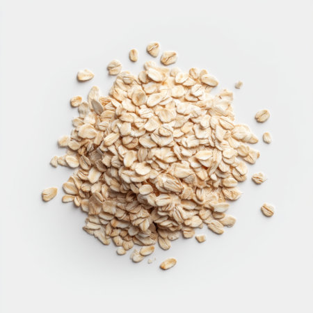 A pile of fresh oats displayed on a clean white background, highlighting the natural texture and versatility of this nutritious ingredient for healthy recipes and snacks.の素材